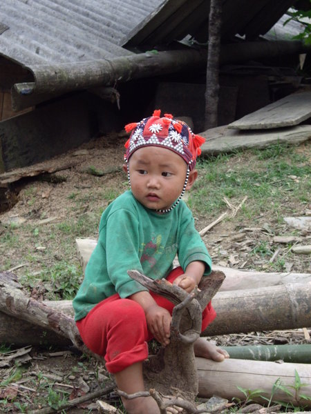 Small boy playing from the red-hat tribe