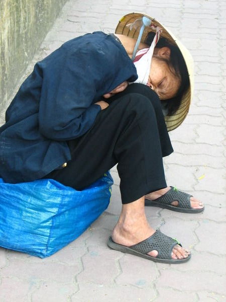 Old woman resting on the streets.