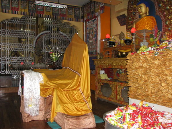At the temple, offerings and the chair for the Dalai Lama