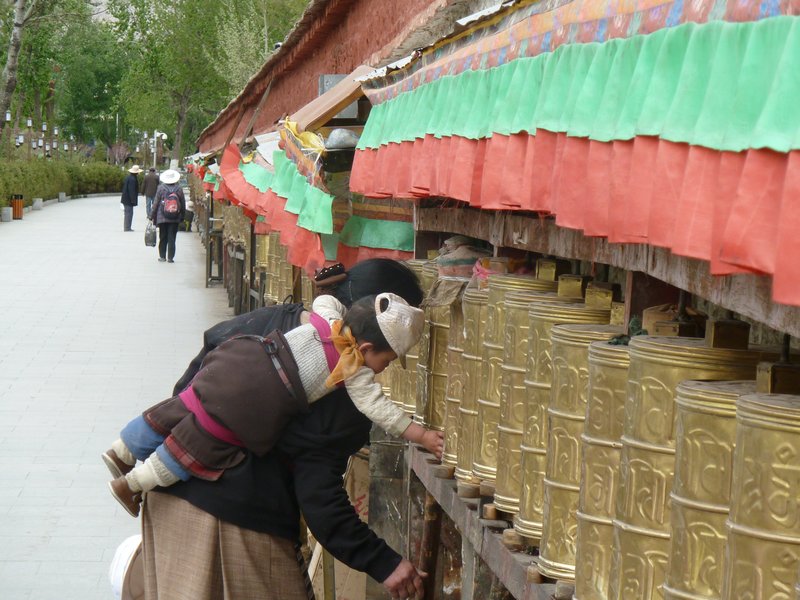 Learning to spin prayer wheels.