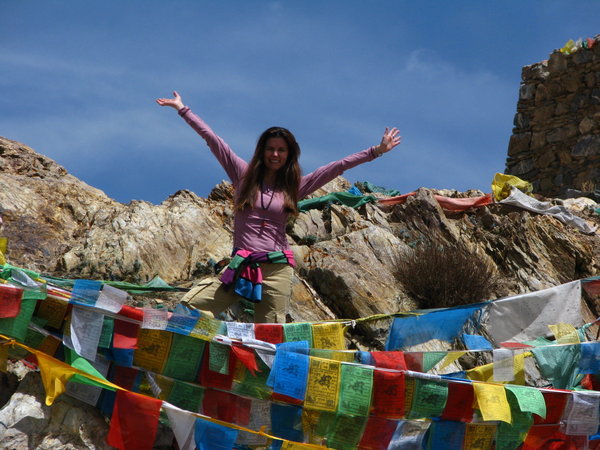 With Prayer flags at Ganden Monastery