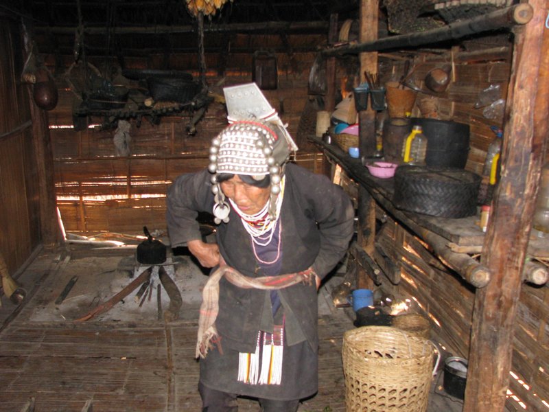 Elder Akha woman in her poor hut