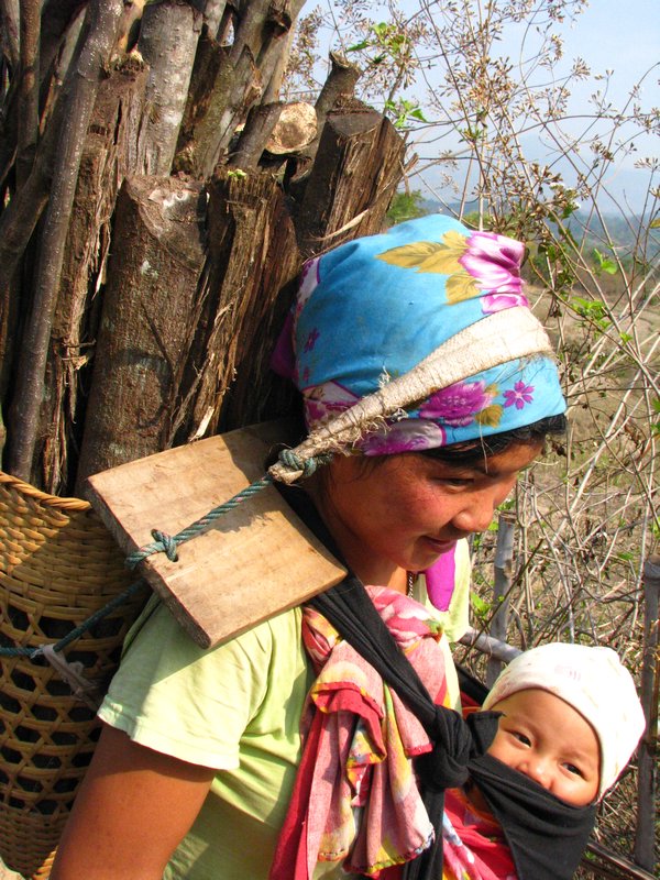 Young Mother with Baby  carries wood 3