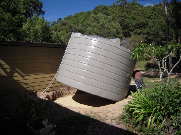 Lowering the rainwater tank into place (with a little help from Antonio)