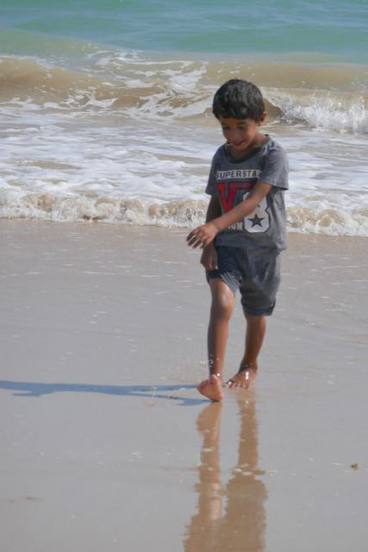 boy playing in the waves