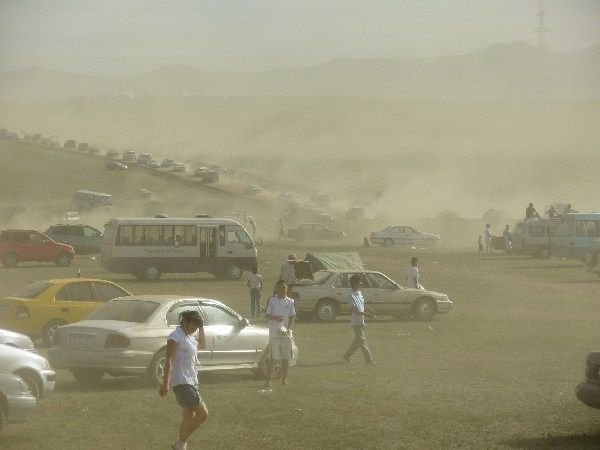 dusty chaos in the parking area after the horseracing