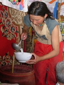 nomadic woman serving airag (fermented mare's milk)