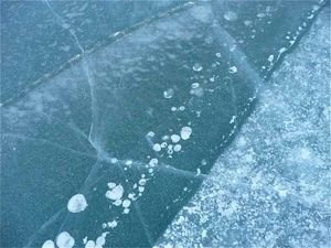 cracks in the ice of a frozen lake