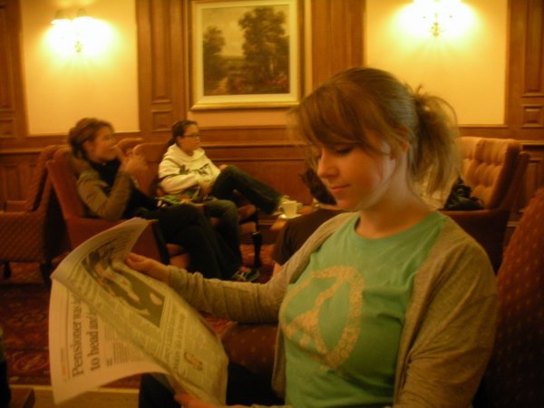 Being studious during tea and reading the newspaper