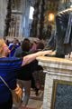 Rubbing the feet of St. Peter statue for luck