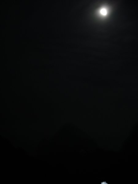 A Majestic View of the Moon atop Bright Peak
