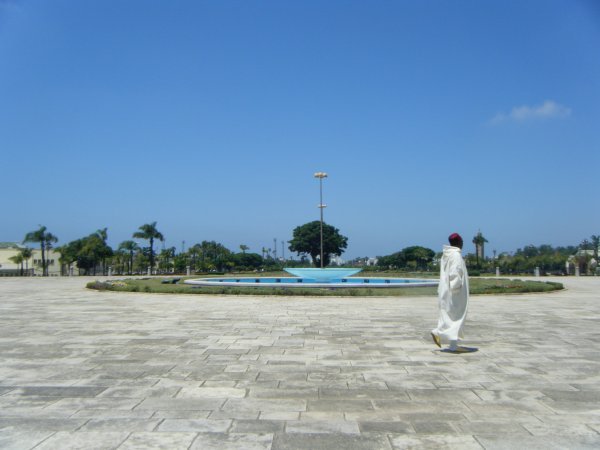 Man walking by fountian.