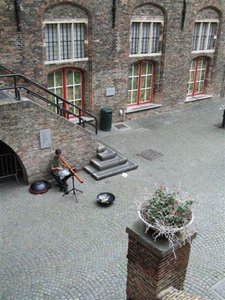 Musician in courtyard of Bruges bell-tower