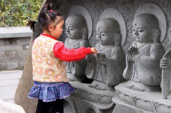 The little girl is great, plays with baby Buddha statues