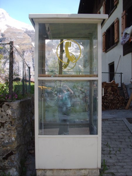 a phone booth in gimmelwald that is also supposedly a shower