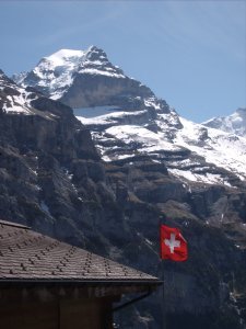 cool shot of swiss flag in murren with jungfrau in background