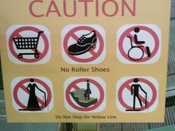 another biazzre malaysia sign advising not to wear ball dresses up the escalator hehe we love finding these 