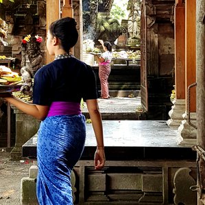 Balinese women burning offerings at a temple in Ubud