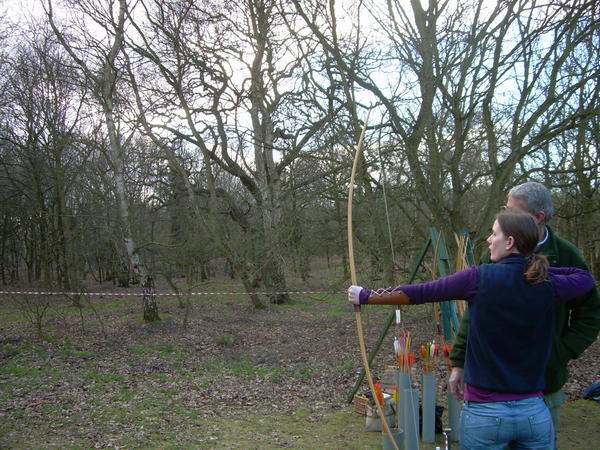 Stacey attempting to do archery