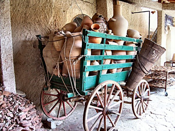 An old wagon filled with pottery.