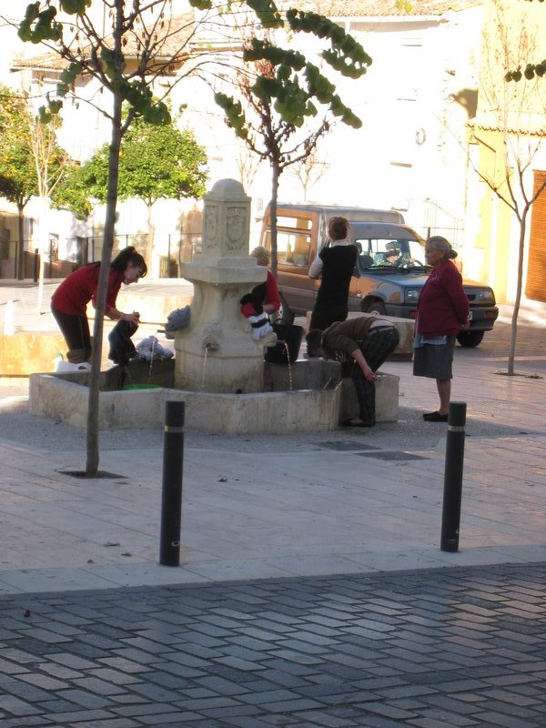 Women washing clothes at one of the fountains