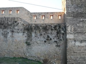 City wall beside the tower