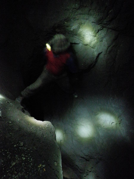 miner climbing down a crevice