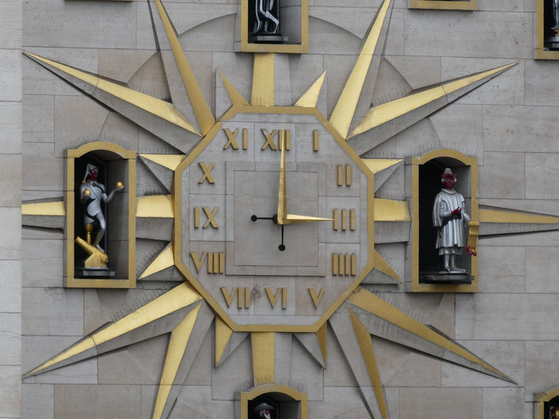 Giant clock with emerging statues