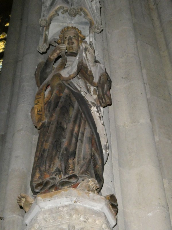 At the right front column in the nave, the grinning angel