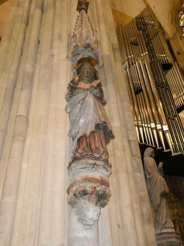 The unsuspecting virgin on the front left column, facing the grinning angel