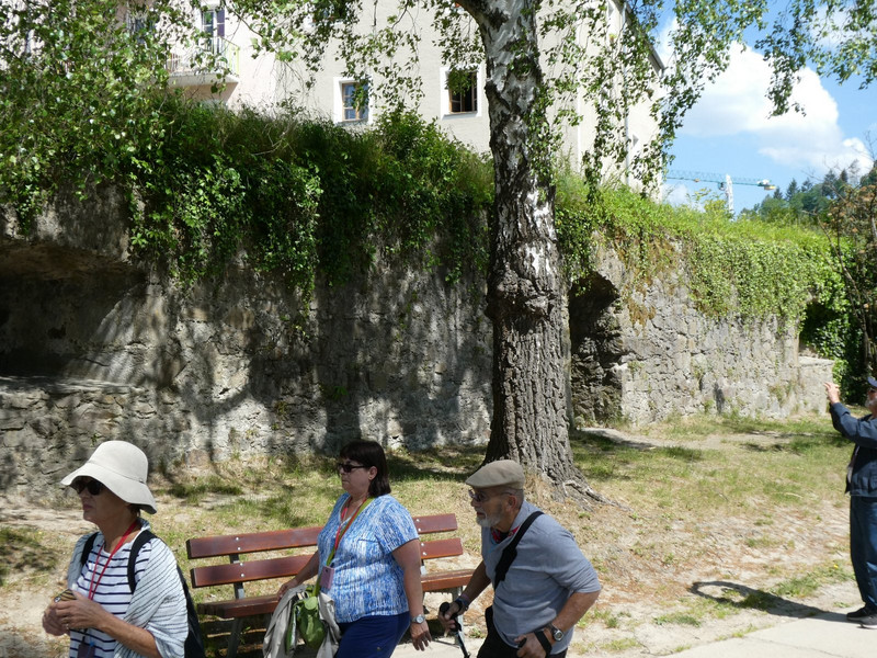 Walking past a section of the old wall of the city.