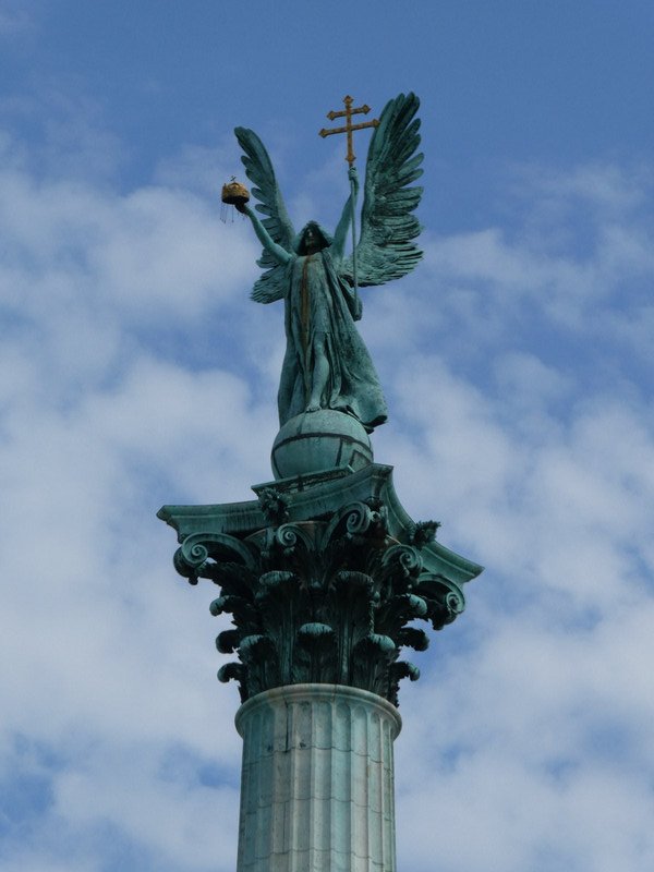 Surmounting the pillar is the Archangel Gabriel holding the Hungarian Holy Crown