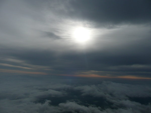 The sun behind the clouds on our descent