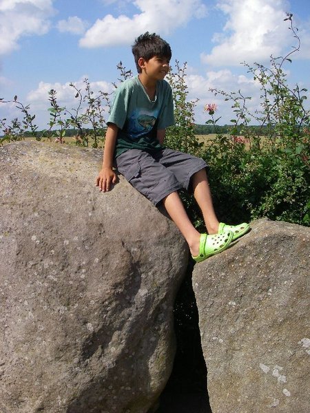 W.. sitting on stone