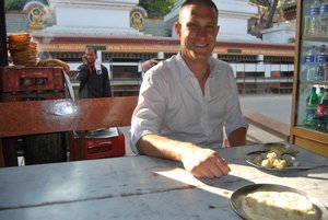 Greg about to sample the local Buff Momos beside the Monkey Temple