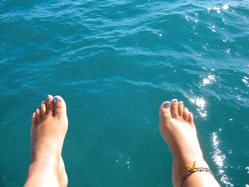 feet hanging off the boat