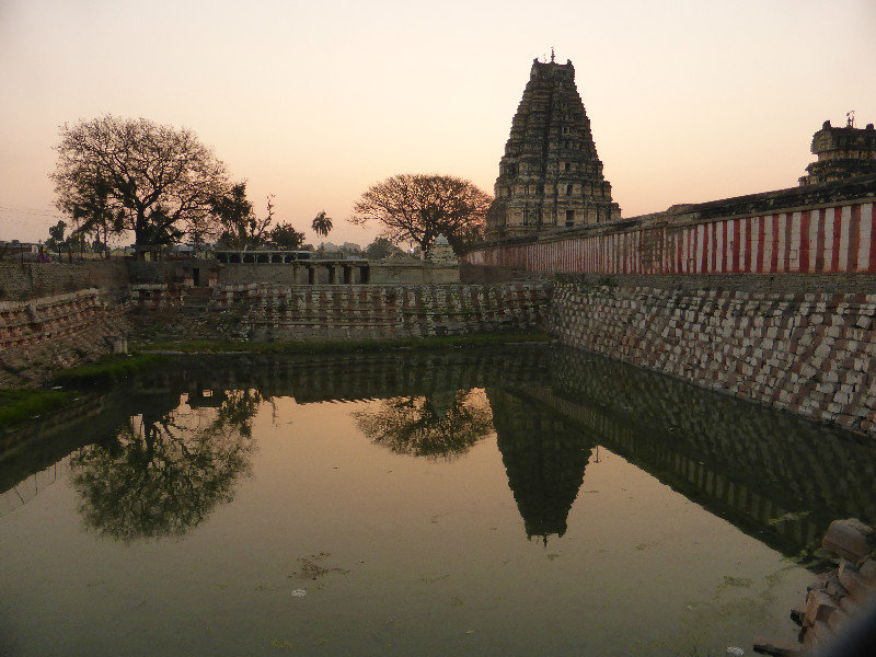 Hampi Temple at sunrise over water tank