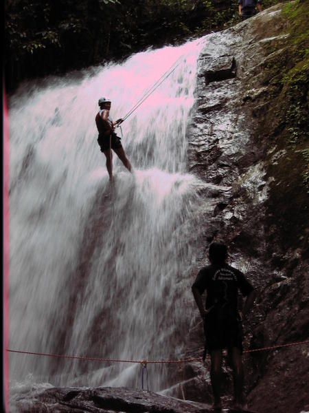 Abseiling down waterfall