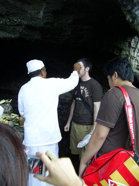 Getting a blessing from the Holy Spring under Tanah Lot