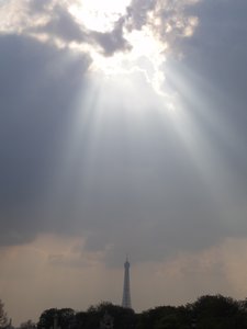 Rays on sunshine with Eiffel Tower in the distance