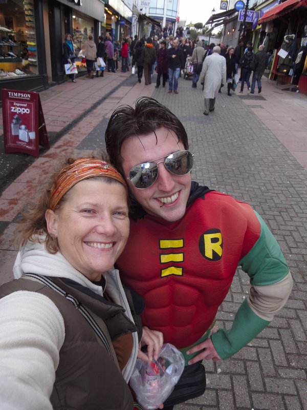 Batman and Robin collecting for charity. I don't remember the Boy Wonder having a lip ring.