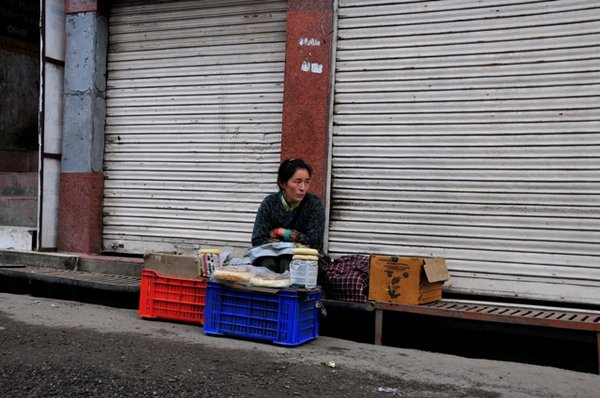 Lhamo Tso selling her bread at the busstand, alone