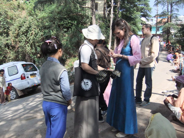 Lhamo Tso and I giving money to the many beggars