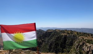 Kurdish flag flies from the dictator's palace