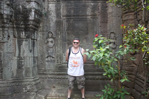 Me standing infront of the carved walls of the main temple
