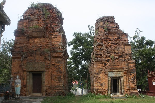 Both tower are constructed of red brick