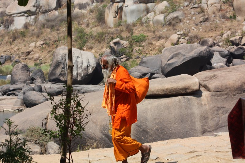 A Sadu walks along the Tungabhadra