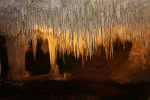 Stalactites hang almost to water level