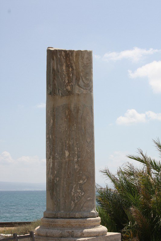 A single broken column stands overlooking the Medditerean