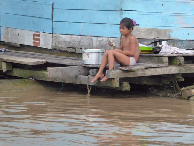 Child bathing on her floating house
